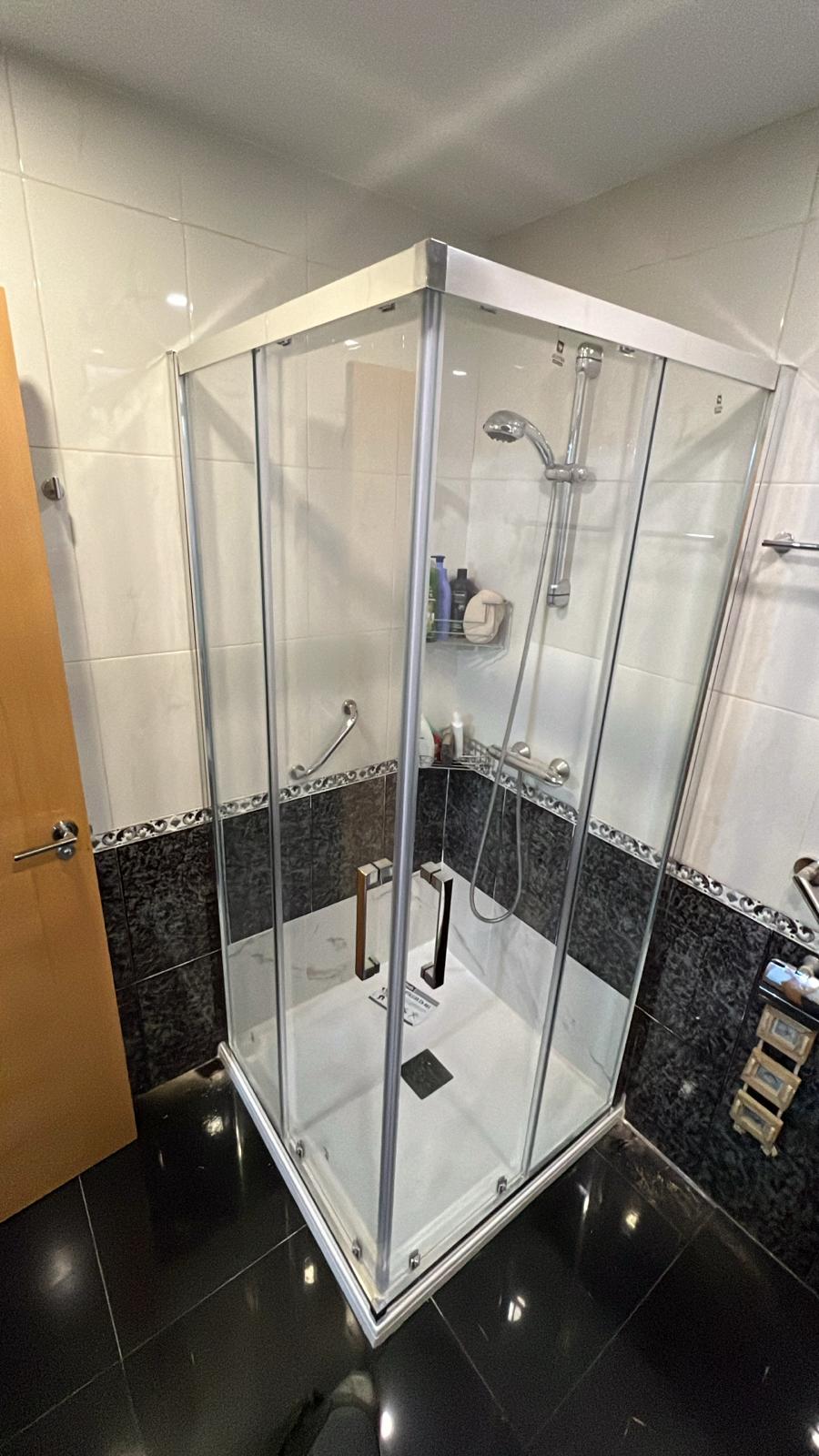 Mampara angular de cristal en baño moderno